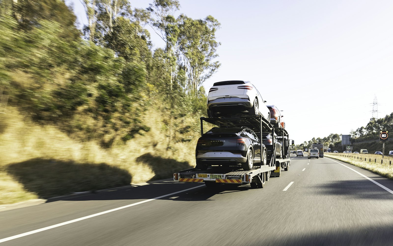 Open car carrier hauling vehicles on the highway